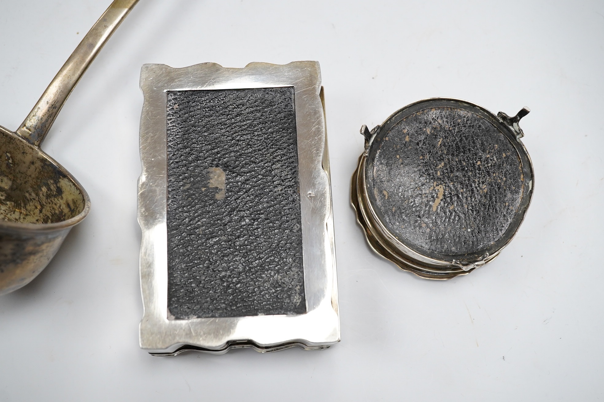 Two George V silver mounted trinket boxes, including rectangular by A & J Zimmerman & Co, 10.7cm, together with a white metal soup ladle. Condition - poor to fair